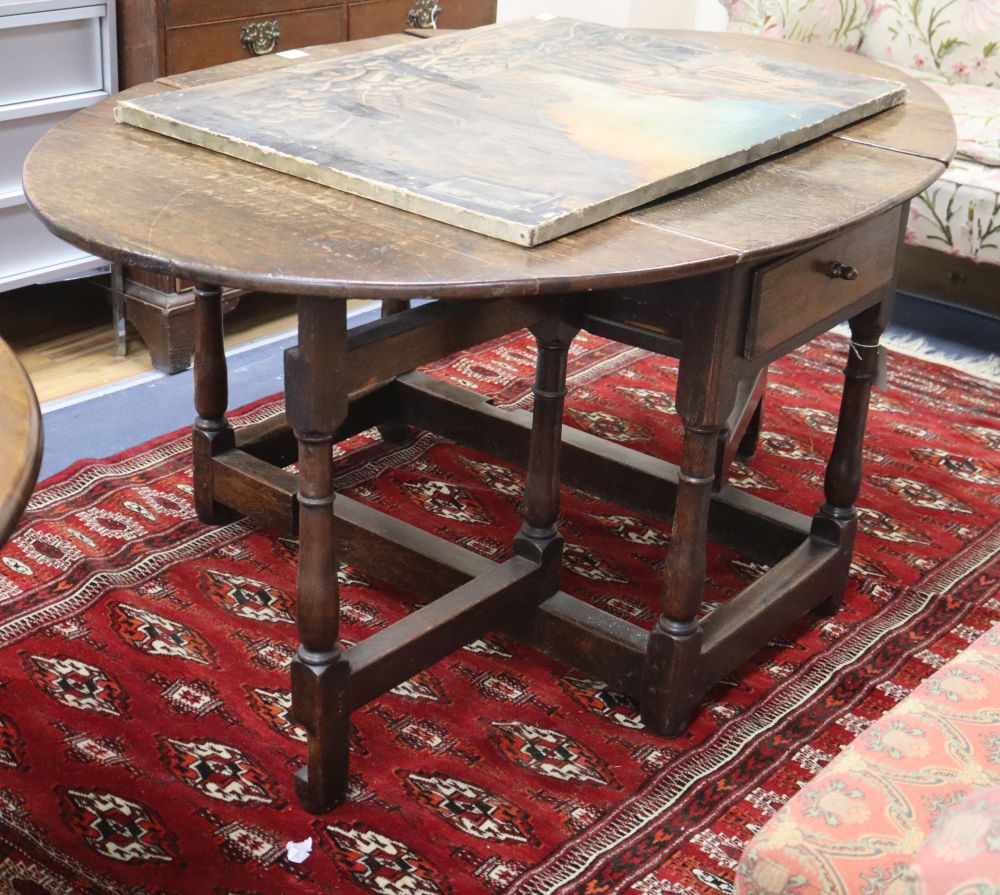 An 18th century oak oval topped gateleg dining table, 150cm extended, W.100cm, H.68cm